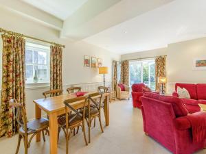 a living room with a table and a red couch at Longlands - Uk49289 in Preston