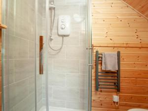 a shower with a glass door in a bathroom at Coot Roundhouse - Uk33890 in Cullompton +11 photos