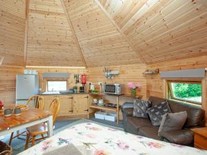 a living room with a couch and a table in a cabin at Coot Roundhouse - Uk33890 in Cullompton