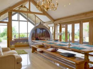 a living room with a table and an oven at Carr End Barn A in Preesall