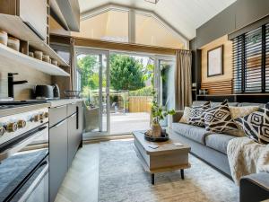 a kitchen and a living room with a couch at Aqueduct Hideaway in Llangollen