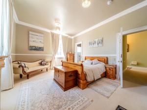 a bedroom with a bed and a tub in it at Mossknowe Escape in Annan +14 photos