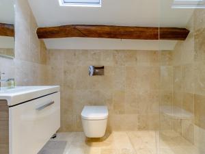 a bathroom with a toilet and a sink at Kilcot Coach House in Hillsley