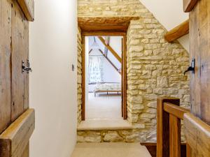 a room with a stone wall and a doorway at Kilcot Coach House in Hillsley +15 photos