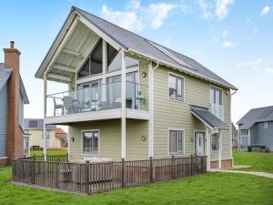 a house with a large balcony on the side of it at Stargazer in Beadnell