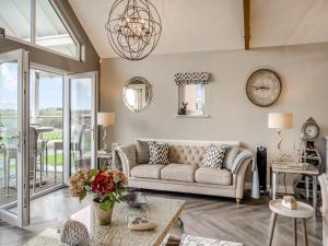 a living room with a couch and a table at Stargazer in Beadnell