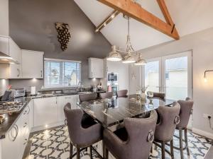 a kitchen with a dining room table and chairs at Stargazer in Beadnell