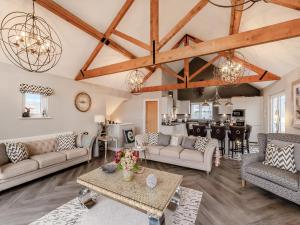 a living room with couches and a table at Stargazer in Beadnell +15 photos