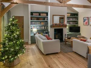 a living room with a christmas tree in it at Windover Barn in Horsham