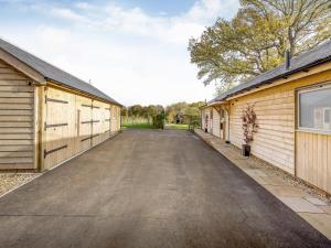 an empty driveway between two buildings at Windover Barn in Horsham +31 photos