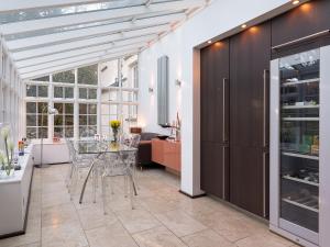 a kitchen with a glass table in a room at Orrest Howe in Windermere