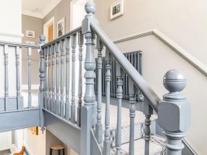 a staircase in a home with grey railings at Riversdelle in Beccles