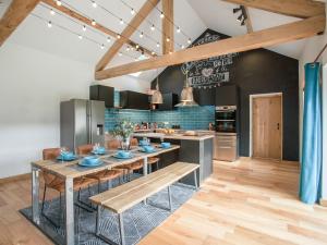 a kitchen with a table with blue dishes on it at The Pendre Longbarn in Pentre-briwnant