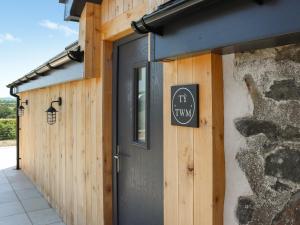 a door to a building with a sign on it at Ty Twm in Criccieth