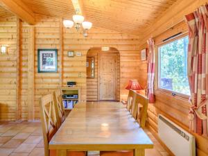a dining room with a wooden table and chairs at Cherry Lodge- Uk37608 in Legbourne