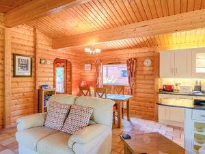 a living room with a couch in a log cabin at Cherry Lodge- Uk37608 in Legbourne