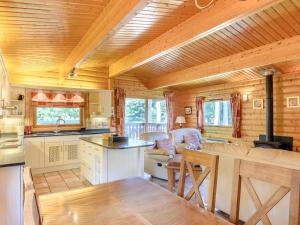 a kitchen and living room in a log cabin at Cherry Lodge- Uk37608 in Legbourne +19 photos