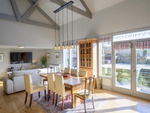 a dining room with a table and chairs and a couch at Penthwaite in Leyburn