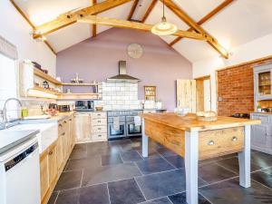 a kitchen with a wooden table in a room at Y Glowty Newydd - Uk31701 in Llandissilio