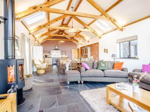 a living room with a couch and a fireplace at Y Glowty Newydd - Uk31701 in Llandissilio