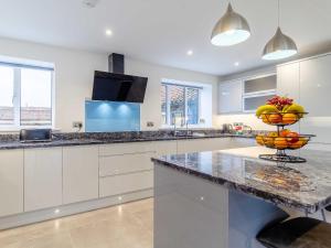 a kitchen with a counter with a bowl of fruit on it at Skylark Barn-Uk31354 in Swaffham
