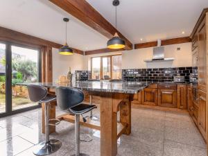 a large kitchen with a large wooden table and chairs at Olive Lodge in Melbourne
