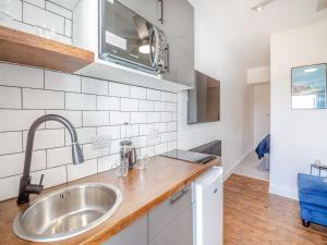 a kitchen with a sink and a counter top at Beachfront Apartment in Rhos-on-Sea