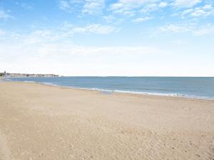 a sandy beach with the ocean in the background at Beachfront Apartment in Rhos-on-Sea +19 photos