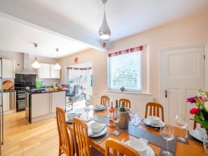 a kitchen and dining room with a table and chairs at Waterside in Llandrillo-yn-Rhôs +31 photos