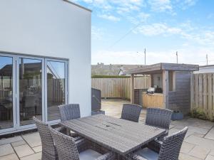 a patio with a table and chairs on a balcony at Hafod Y Morfa - Uk48829 in Harlech
