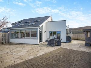a white house with windows and a patio at Hafod Y Morfa - Uk48829 in Harlech