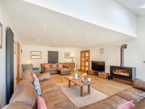 a living room with a couch and a fireplace at Hafod Y Morfa - Uk48829 in Harlech +27 photos