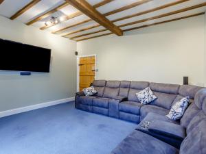 a living room with a couch and a flat screen tv at Old Upper Gwestydd in Highgate +29 photos
