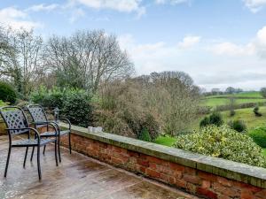 two chairs sitting on top of a brick wall at Old Upper Gwestydd in Highgate