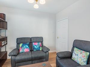 a living room with a couch and a chair at Seacroft Lodge in Skegness
