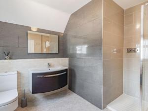 a bathroom with a toilet and a sink and a shower at Seacroft Lodge in Skegness