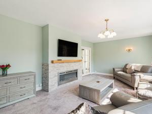 a living room with a couch and a fireplace at Seacroft Lodge in Skegness