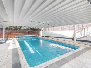 a swimming pool in a house with a ceiling at Seacroft Lodge in Skegness