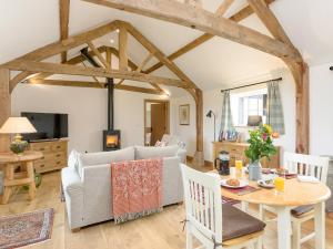 a living room with a couch and a table at The Old Dairy-Ukc2112 in Royal Wootton Bassett