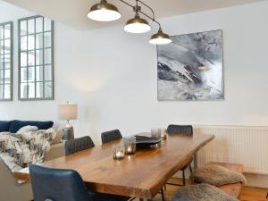 a dining room with a wooden table and chairs at Old Parish Hall in Ramsgate +32 photos