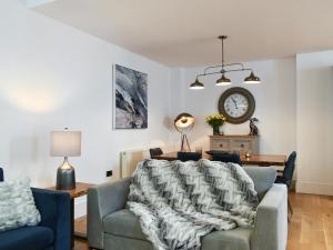 a living room with a couch and a clock on the wall at Old Parish Hall in Ramsgate