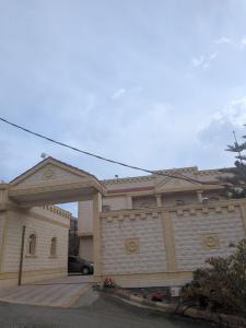 a building with a garage with a car in it at شقق ضوء القمر Moonlight Apartment in Rahwat al Barr +1 photo