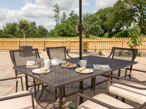 a black table with plates of food on it at Eastlands Barn in East Barkwith
