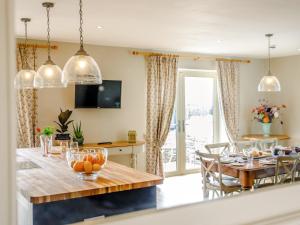 a kitchen and dining room with a table and chairs at The Stables in Cheddar