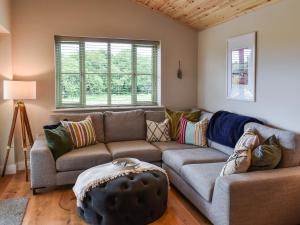 a living room with a couch and a table at Hobby Lodge in Saint Columb Major