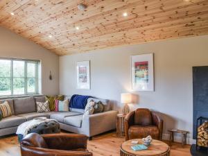 a living room with a couch and chairs at Hobby Lodge in Saint Columb Major