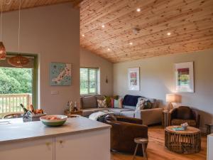 a kitchen and living room with a couch and a table at Hobby Lodge in Saint Columb Major