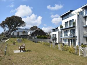 a yard with a bench in front of houses at Seascape in Sandown