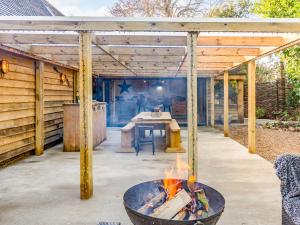 a patio with a fire pit and a table at Old Shires Barn in Norton +44 photos