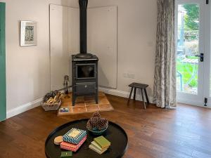 a living room with a wood stove in a room at The Cowshed - Uk50803 in Cratfield +10 photos